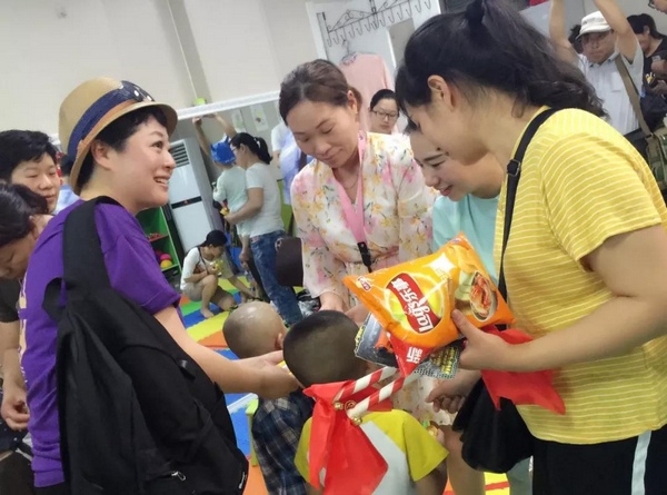 主持人周迪給孩子們分發(fā)禮物 主持人周迪給孩子們分發(fā)禮物