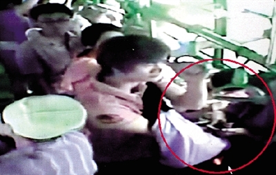 一名小偷拉開了乘客李女士的包，并在包里摸了足足3分多鐘。最終，李女士被偷了2.4萬多元錢。”(翻拍視